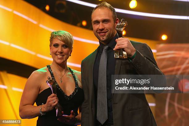 Christina Obergfoell and Robert Harting pose with their Athlete of the Year 2013 award after the Sportler des Jahres 2013 gala at the Kurhaus...