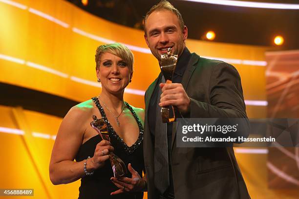 Christina Obergfoell and Robert Harting pose with their Athlete of the Year 2013 award after the Sportler des Jahres 2013 gala at the Kurhaus...