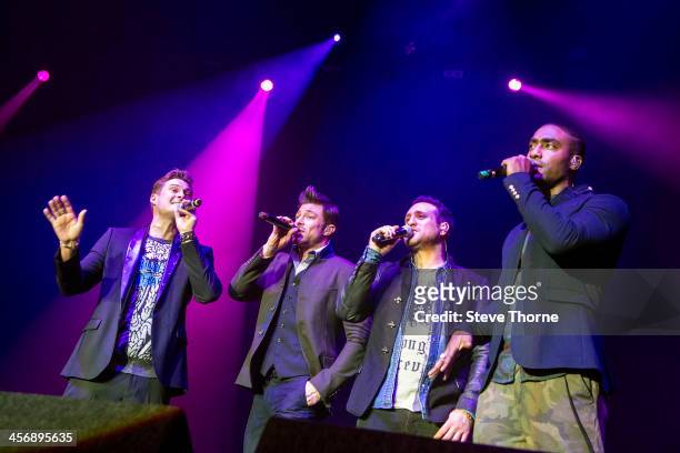 Lee Ryan, Duncan James, Anthony Costa and Simon Webbe of Blue perform on stage at LG Arena on December 15, 2013 in Birmingham, United Kingdom.