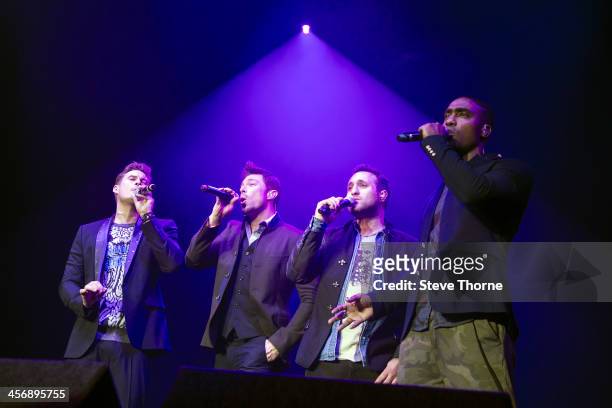 Lee Ryan, Duncan James, Anthony Costa and Simon Webbe of Blue perform on stage at LG Arena on December 15, 2013 in Birmingham, United Kingdom.
