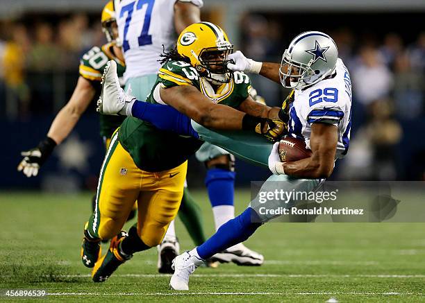Running back DeMarco Murray of the Dallas Cowboys is tackled by defensive end Josh Boyd of the Green Bay Packers during a game at AT&T Stadium on...
