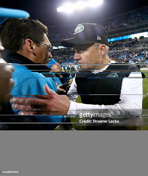 Head coach Ron Rivera of the Carolina Panthers shakes hands with head coach Rex Ryan of the New York Jets after their game at Bank of America Stadium...