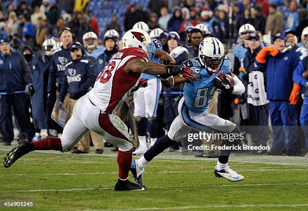 Nate Washington of the Tennessee Titans is tackled by Daryl Washington of the Arizona Cardinals at LP Field on December 15, 2013 in Nashville,...