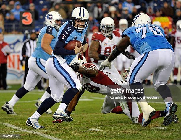 Quarterback Ryan Fitzpatrick of the Tennessee Titans is pressured in the pocket by Daryl Washington of the Arizona Cardinals at LP Field on December...