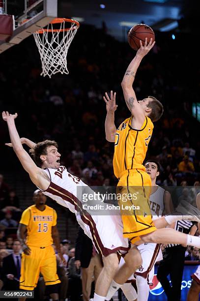 Denver Pioneers forward Dom Samac gets called for a foul as Wyoming Cowboys guard Nathan Sobey drives to the basket during the first half December...