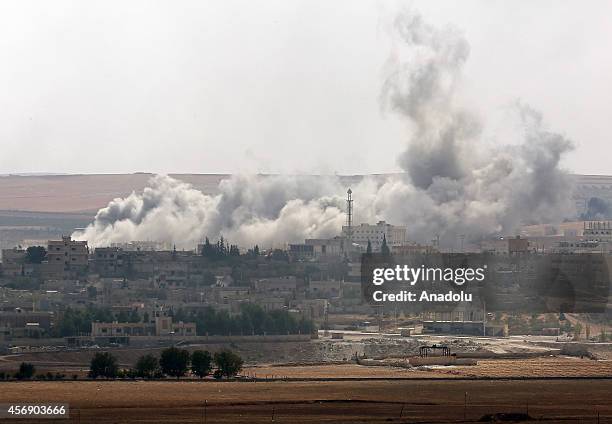 Black smoke, rising in Ayn al-Arab after airstrikes staged by US-led coalition air forces, is seen from Suruc district of Turkey's Sanliurfa on...