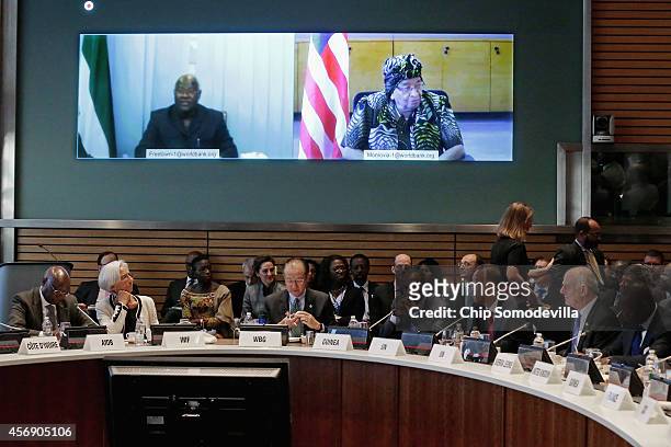 Sierra Leone President Bai Koroma and Liberia President Ellen Johnson Sirleaf join a meeting via video link with Finance ministers and...