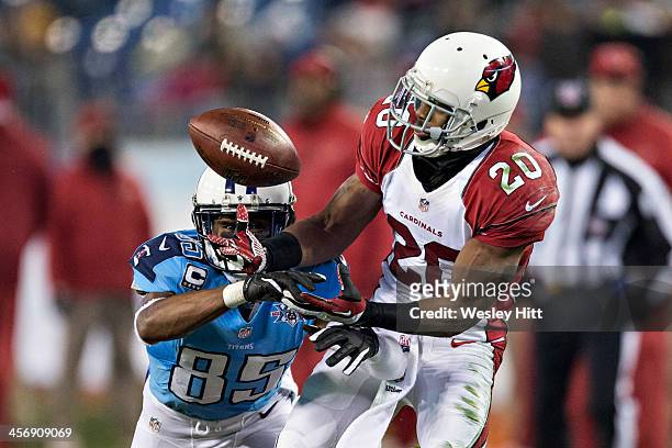 Antoine Cason of the Arizona Cardinals intercepts a pass and scores a touchdown thrown to Nate Washington of the Tennessee Titans at LP Field on...