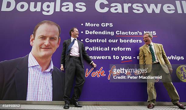 United Kingdom Independence Party candidate Douglas Carswell stands with party leader Nigel Farage on a mobile poster truck on polling day on October...