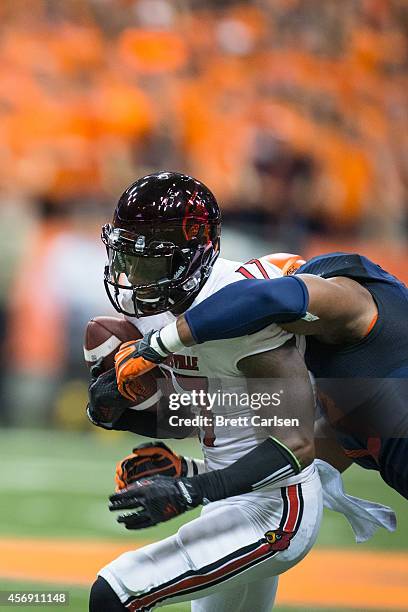 James Quick of the Louisville Cardinals is brought down by Micah Robinson of the Syracuse Orange after a first quarter first down reception on...