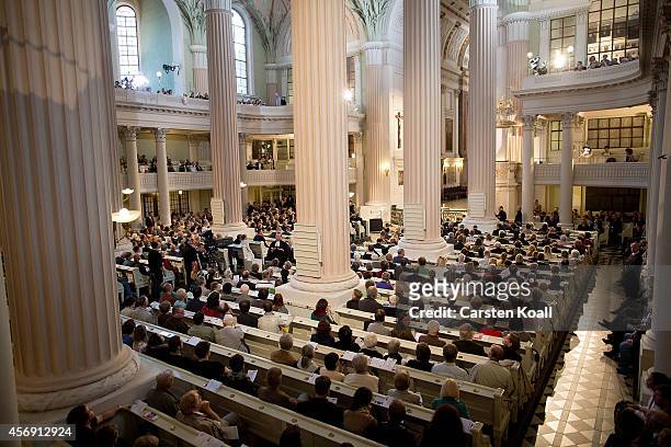People attend mass in the Nikolaikirche church as part of commemorations marking the 25th anniversary of the mass protests in Leipzig that preceded...
