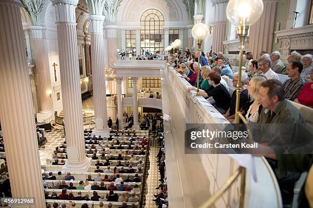 People attend mass in the Nikolaikirche church as part of commemorations marking the 25th anniversary of the mass protests in Leipzig that preceded...