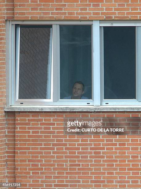 Husband of Spanish nurse Teresa Romero infected with the ebola virus, Javier Limon, looks from a window at the Carlos III hospital in Madrid on...