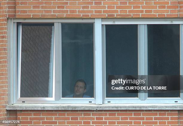 Husband of Spanish nurse Teresa Romero infected with the ebola virus, Javier Limon, looks from a window at the Carlos III hospital in Madrid on...