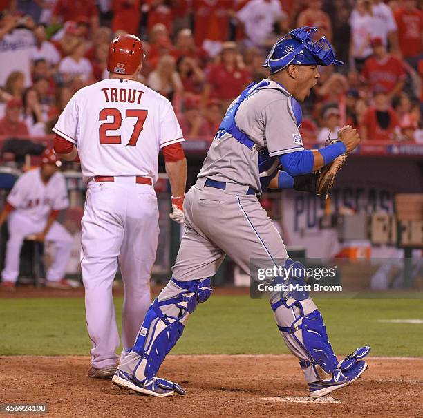 Salvador Perez of the Kansas City Royals celebrates after Mike Trout of the Los Angeles Angels of Anaheim strikes out to end the game during Game 2...