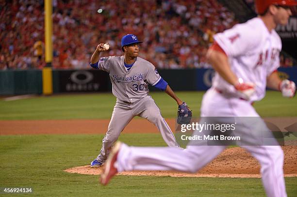 Yordano Ventura of the Kansas City Royals throws the ball to first base against the Los Angeles Angels of Anaheim during Game 2 of the American...