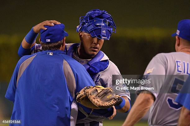 Salvador Perez of the Kansas City Royals hugs a teammate after the game against the Los Angeles Angels of Anaheim during Game 2 of the American...
