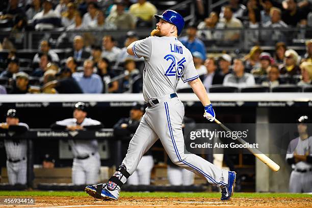 Adam Lind of the Toronto Blue Jays swings at a pitch during a game against the New York Yankees at Yankee Stadium on September 18, 2014 in the Bronx...