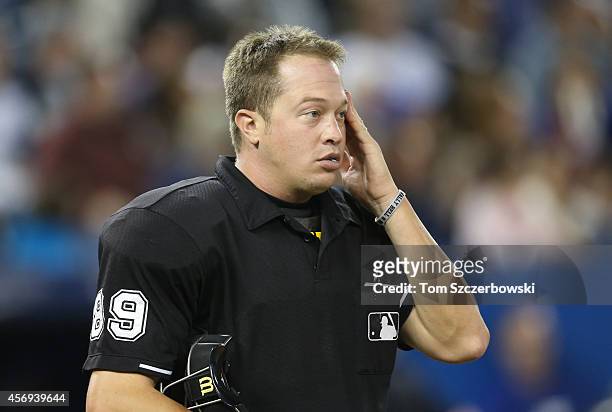 Home plate umpire Cory Blaser wears a bracelet in memory of Wally Bell during the Toronto Blue Jays MLB game against the Seattle Mariners on...