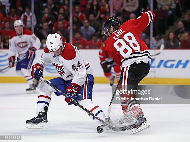 Patrick Kane of the Chicago Blackhawks and Davis Drewiske of the Montreal Canadiens battle for the puck during a preseason game at the United Center...