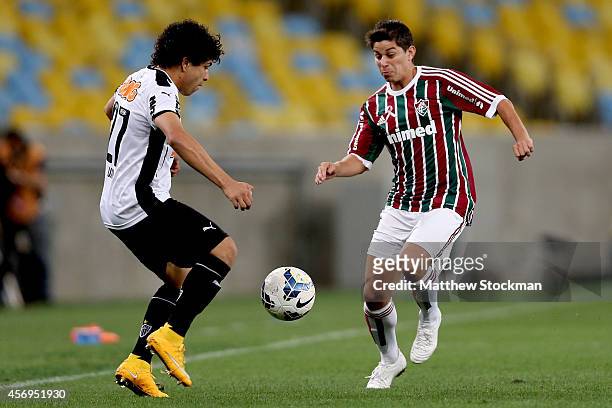 Luan of Atletico MG and Conca of Fluminense battle for control of the ball during a match between Fluminense and Atletico MG as part of Brasileirao...