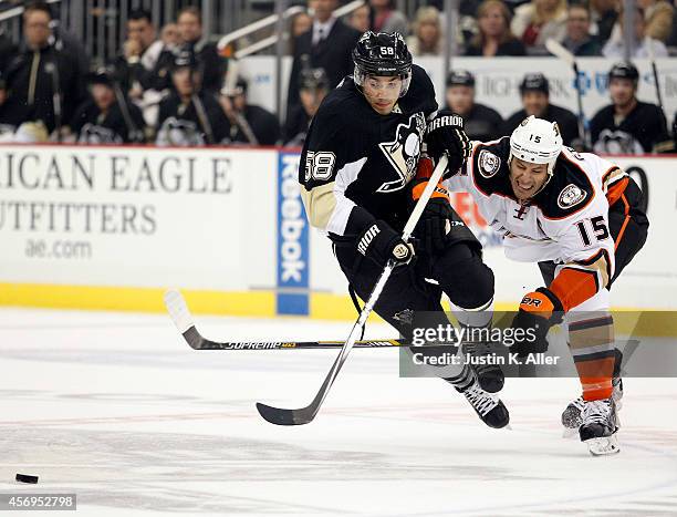 Kris Letang of the Pittsburgh Penguins is tripped by Ryan Getzlaf of the Anaheim Ducks in the first period during the season opener at Consol Energy...