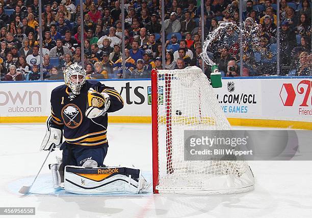 Second period goal by Jack Skille of the Columbus Blue Jackets sends water splashng from the bottle behind goaltender Jhonas Enroth of the Buffalo...