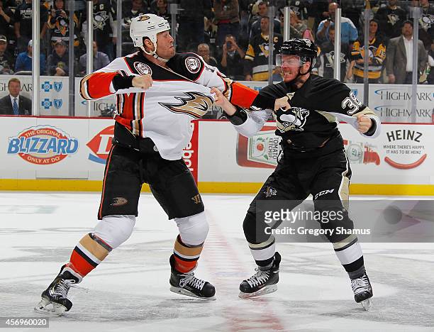 Zach Sill of the Pittsburgh Penguins and Clayton Stoner of the Anaheim Ducks fight during the third period at Consol Energy Center on October 9, 2014...