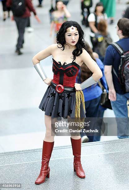 Comic Con attendee poses as Wonder Woman during the 2014 New York Comic Con at Jacob Javitz Center on October 9, 2014 in New York City.