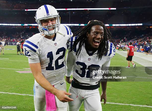 Andrew Luck and Sergio Brown of the Indianapolis Colts walk off the field after defeating the Houston Texans 33-28 at NRG Stadium on October 9, 2014...