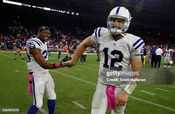 Andrew Luck and Loucheiz Purifoy of the Indianapolis Colts walk off the field after defeating the Houston Texans 33-28 at NRG Stadium on October 9,...