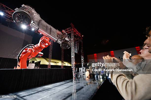 Elon Musk, CEO of Tesla, unveils the dual engine chassis of the new Tesla 'D' model at the Hawthorne Airport October 09, 2014 in Hawthorne,...