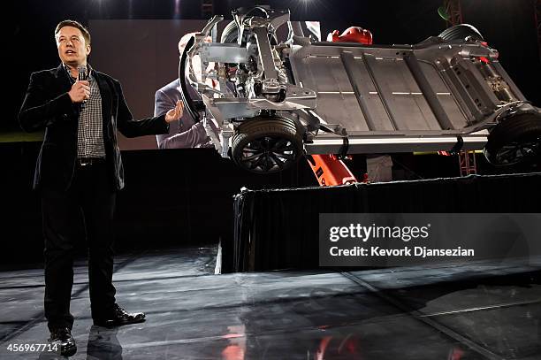 Elon Musk, CEO of Tesla, unveils the dual engine chassis of the new Tesla 'D' model at the Hawthorne Airport October 09, 2014 in Hawthorne,...