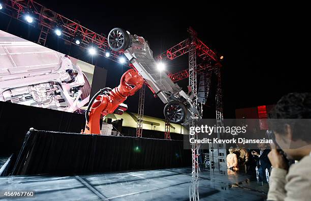 Elon Musk, CEO of Tesla, unveils the dual engine chassis of the new Tesla 'D' model at the Hawthorne Airport October 09, 2014 in Hawthorne,...