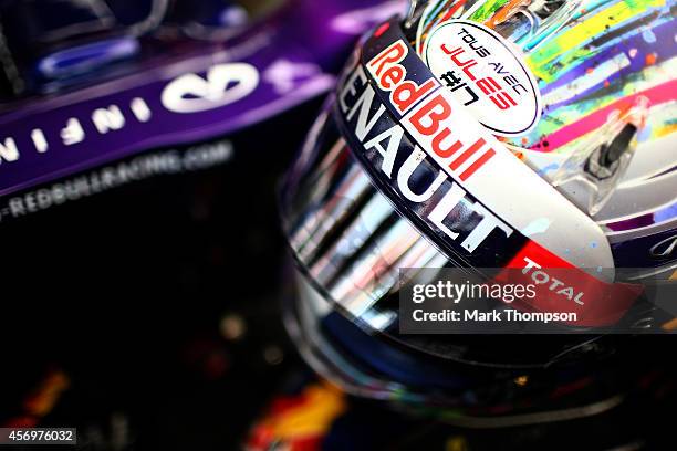 Sebastian Vettel of Germany and Infiniti Red Bull Racing's helmet displaying the message 'tous avec Jules' in support of Jules Bianchi of France and...