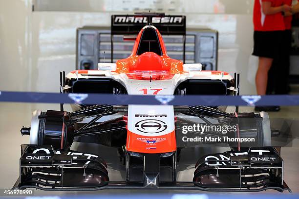 Jules Bianchi of France and Marussia's car remains in the garage during practice ahead of the Russian Formula One Grand Prix at Sochi Autodrom on...