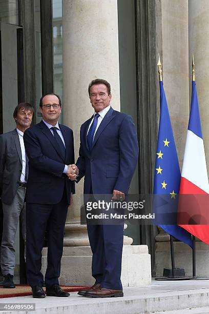 French President Francois Hollande receives Arnold Schwarzenegger at Elysee Palace on October 10, 2014 in Paris, France.