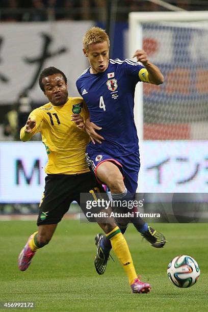 Dane Richards of Jamaica and Keisuke Honda of Japan competes for the ball during the international friendly match between Japan and Jamaica at Denka...
