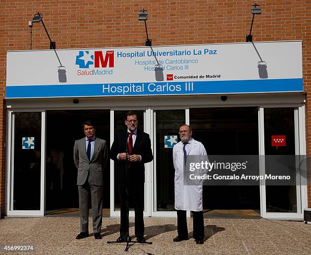 Spanish Prime Minister Mariano Rajoy gives a speech at the front door of Carlos III hospital, watched by Madrid Regional President Ignacio Gonzalez...