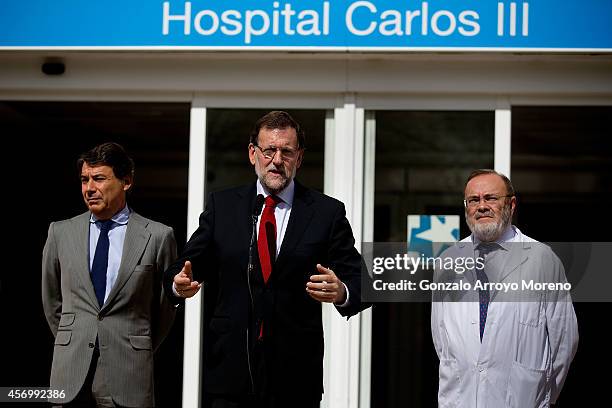 Spanish Prime Minister Mariano Rajoy gives a speech at the front door of Carlos III hospital, watched by Madrid Regional President Ignacio Gonzalez...