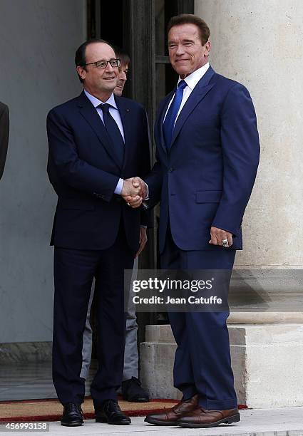 French President Francois Hollande receives Arnold Schwarzenegger to talk about climate change at Elysee Palace on October 10, 2014 in Paris, France.