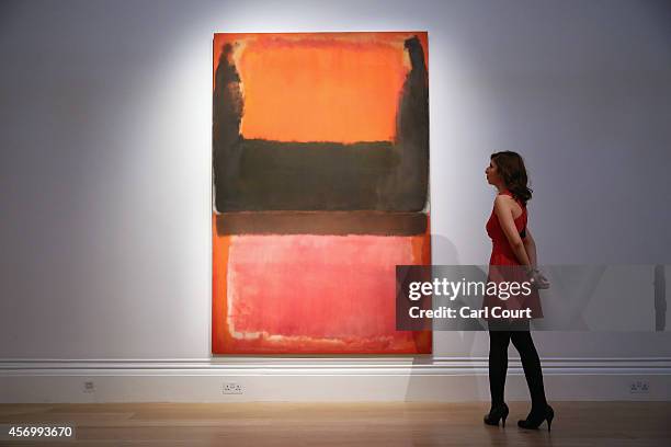 An employee poses next to a painting by Mark Rothko entitled 'Red, Brown, Black and Orange'. Due to be auctioned in New York on November 7th, it is...