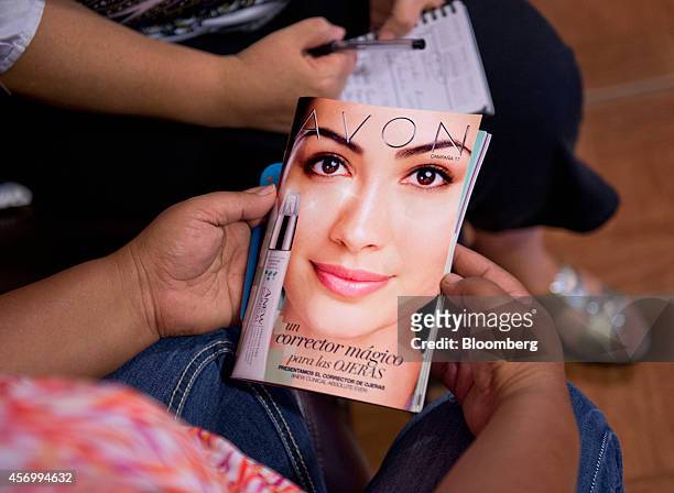 Customer views an Avon Products Inc. Product catalog in McAllen, Texas, U.S., on Thursday, Aug. 28, 2014. The top 10 U.S. Avon districts are mostly...