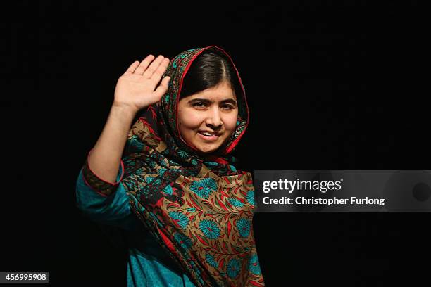 Malala Yousafzai waves to the crowd at a press conference at the Library of Birmingham after being announced as a recipient of the Nobel Peace Prize,...