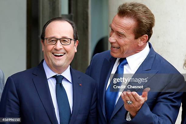 French President Francois Hollande welcomes US actor, former governor of California and founding chair of the R20 initiative Arnold Schwarzenegger...