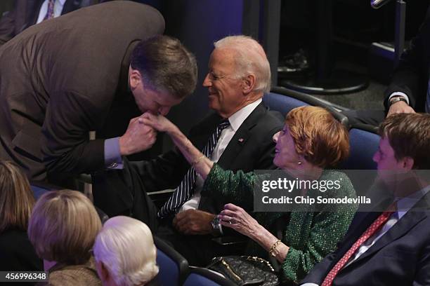 Former Reagan White House Assistant Press Secretary Mark Weinberg kisses the hand of Sarah Brady, widow of former White House Press Secretary James...