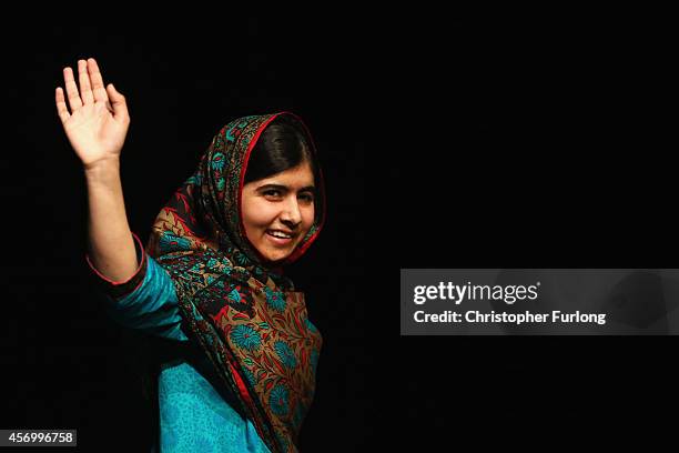 Malala Yousafzai acknowledges the crowd at a press conference at the Library of Birmingham after being announced as a recipient of the Nobel Peace...