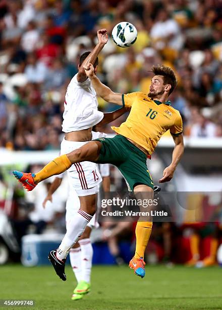 James Holland of Australia and Ismail Ahmed Ismail Mohammed of the U.A.E. Challnge for the ball durng the international friendly between the UAE and...