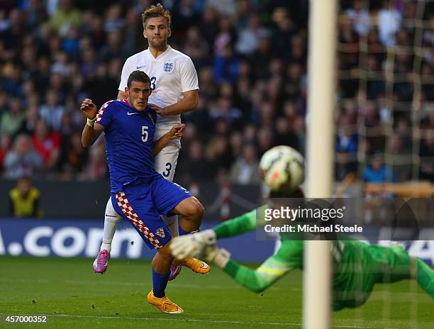 Luke Shaw of England shoots past Matej Delac of Croatia only to see his shot hit the post during the UEFA U21 Championship Playoff First Leg match...