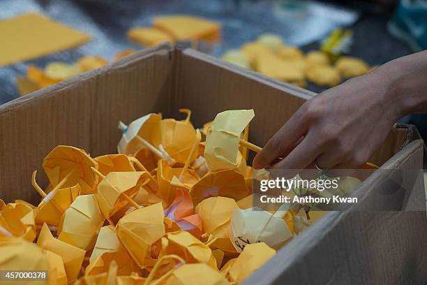 Protesters make paper craft umbrellas ouside of Hong Kong Government Complex on October 10, 2014 in Hong Kong. The rally comes after government...